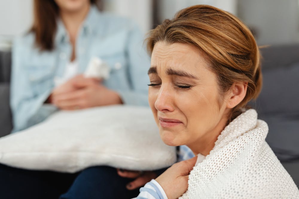 A Crying Woman in White Knitted Sweater