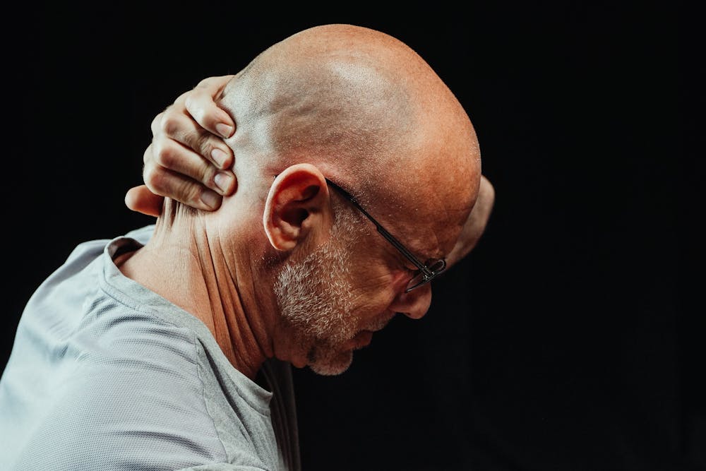 Close-Up Photo of Man Having a Neck Pain