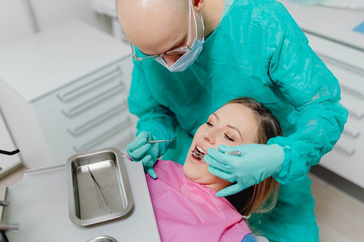 A Woman Wearing a Dental Bin Undergoing a Dental ExaminationA Woman Wearing a Dental Bin Undergoing a Dental Examination