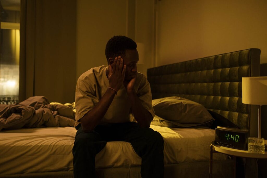 A Man Sitting on a Bed