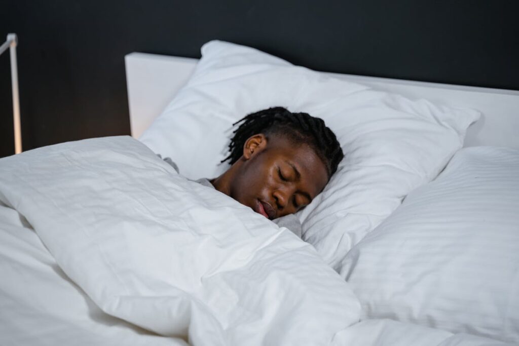 Man Lying on White Bed